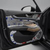 Detail interior mobil yang mewah dan hening, menunjukkan jenis peredam mobil terbaik yang berlapis-lapis pada panel pintu, dengan tekstur karet, foil, dan serat yang menonjol. Gambar ini realistis, sangat detail, dan menggunakan pencahayaan studio untuk menonjolkan kesan tenang dan nyaman.